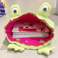 Cloth frog with its mouth open side, gift cards are in its mouth.
