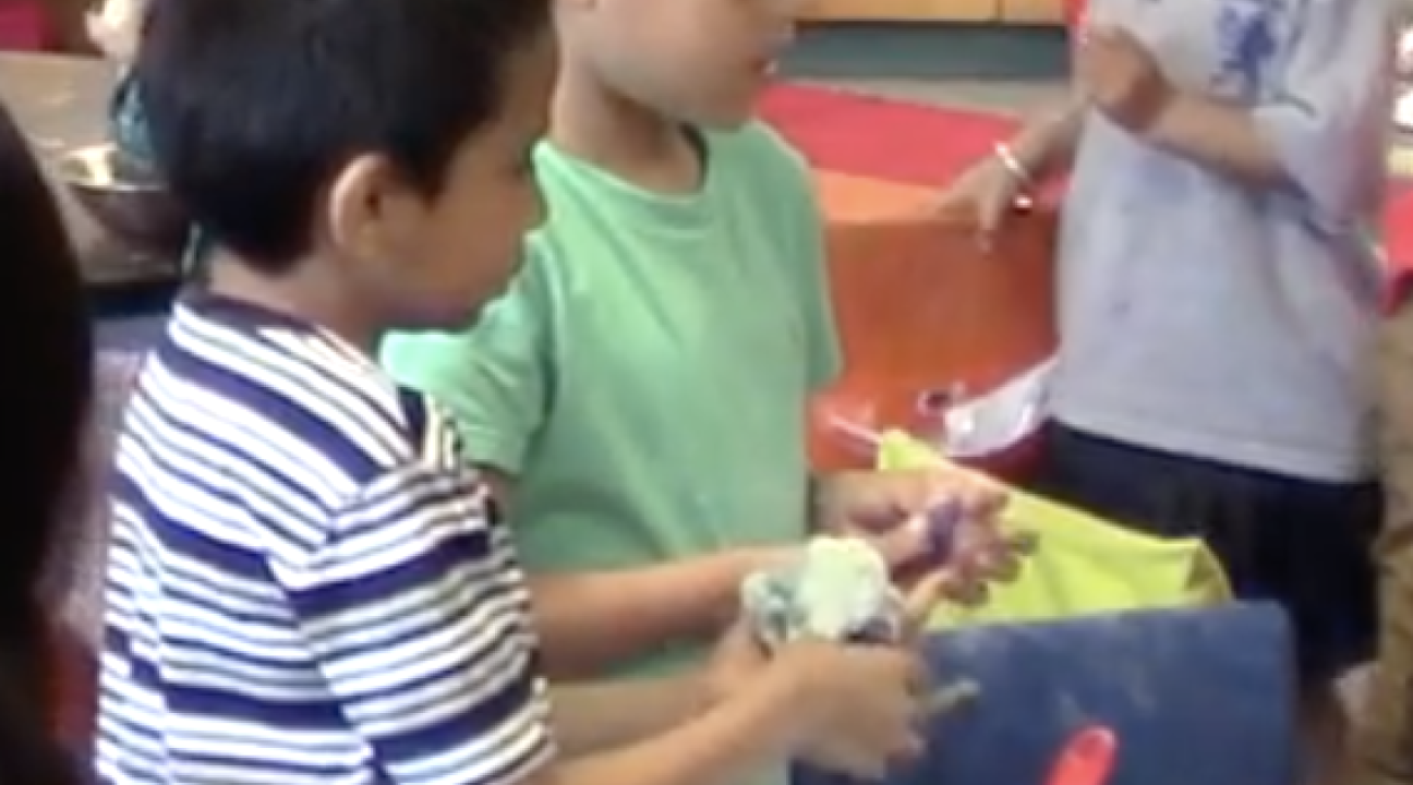 Children mixing ingredients in a bowl.