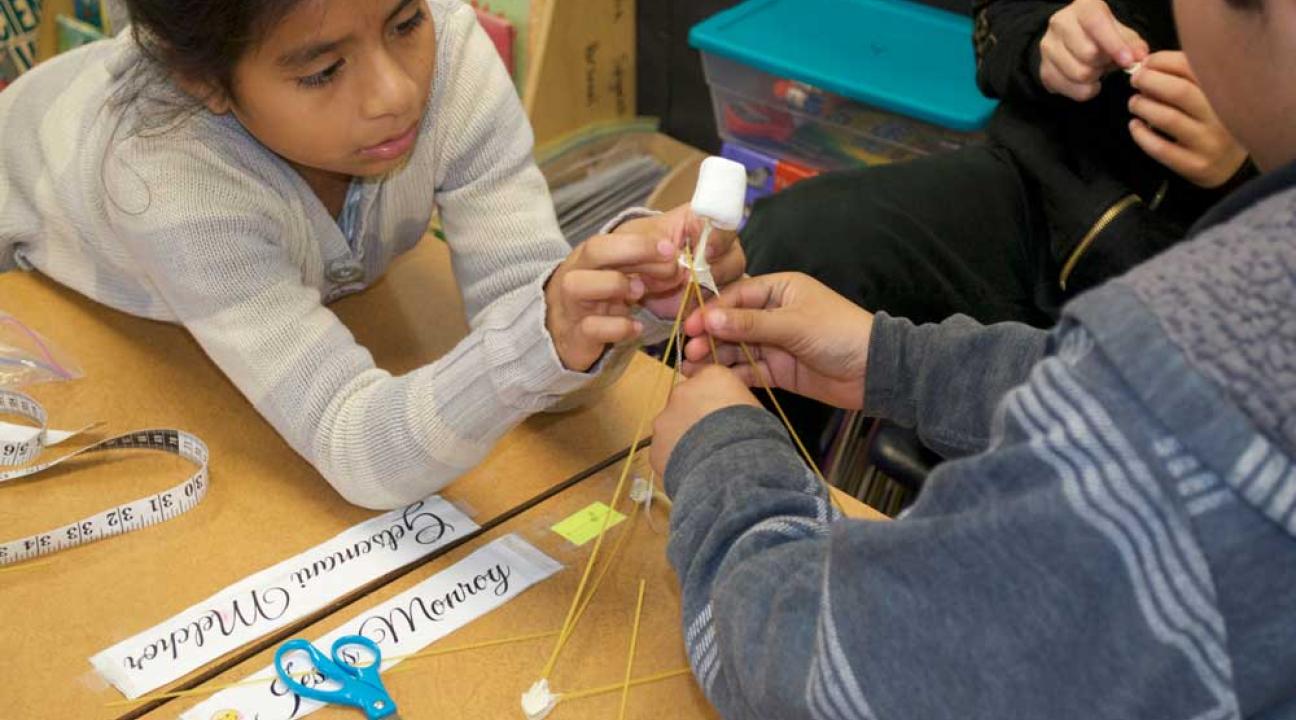 Two people creating a structure.