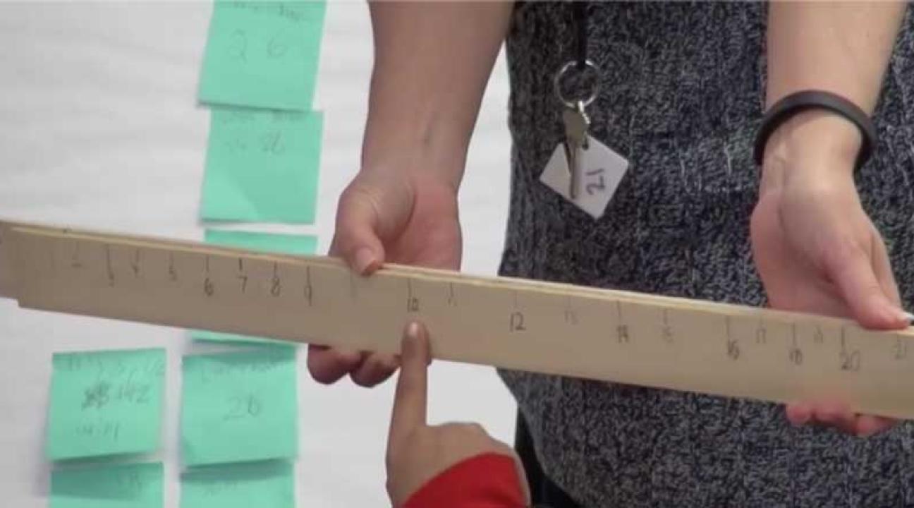 Yardstick being held by 2 hands.