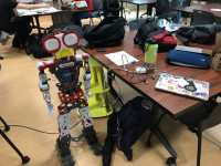 A 3 foot robot looks into the camera