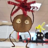 Brown round share with pipe cleaners arms and legs.