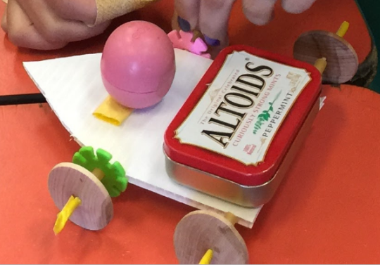 4 wheeled toy car with a Altoids tin.