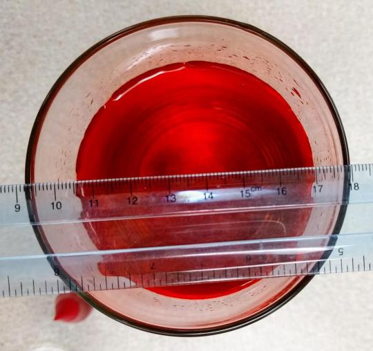 Red liquid in a glass cup